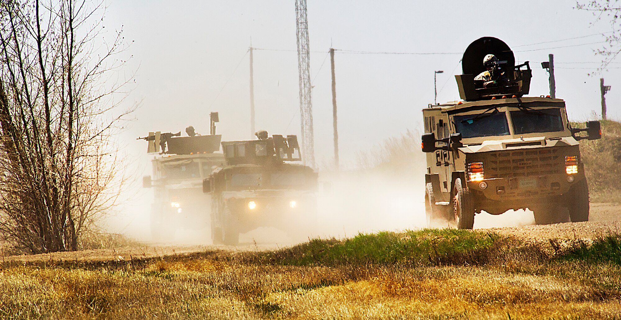 Members of the 791st Missile Security Forces Squadron convoy response force and 91st Security Support Squadron tactical response force respond to opposing forces during a recapture, recovery exercise at Minot Air Force Base, N.D., May 15, 2014. The purpose of this training is to maintain readiness for launch facility recapture. (U.S. Air Force photo/Senior Airman Brittany Y. Auld