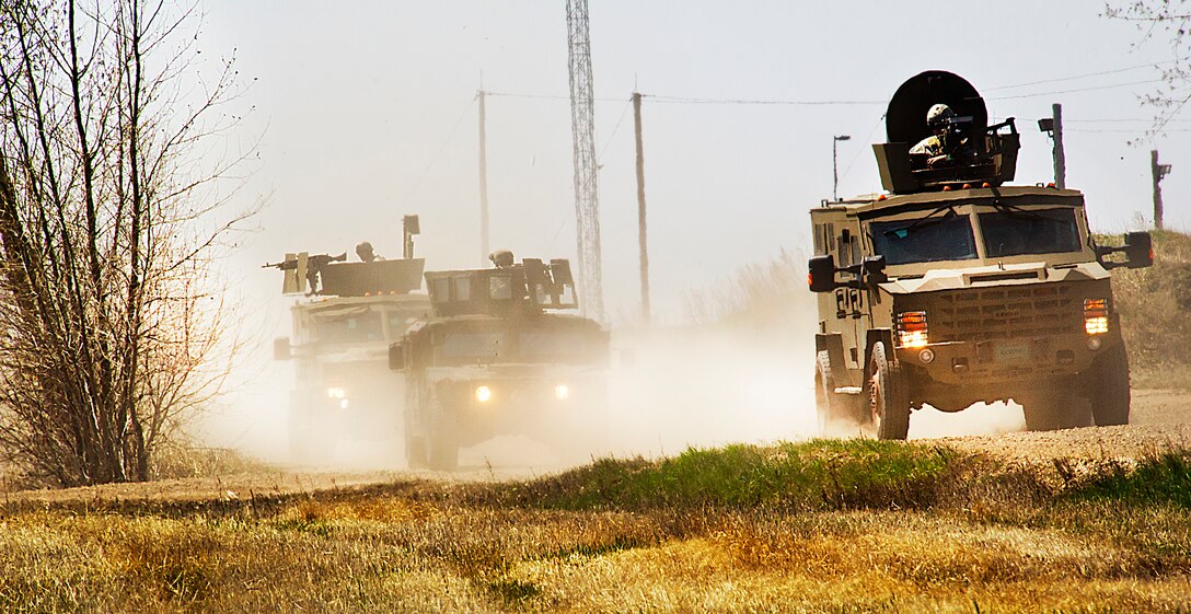 Members of the 791st Missile Security Forces Squadron convoy response force and 91st Security Support Squadron tactical response force respond to opposing forces during a recapture, recovery exercise at Minot Air Force Base, N.D., May 15, 2014. The purpose of this training is to maintain readiness for launch facility recapture. (U.S. Air Force photo/Senior Airman Brittany Y. Auld