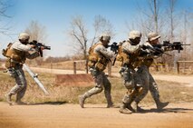 Tactical response force members from the 91st Security Support Squadron respond to opposing forces during a recapture, recovery exercise at Minot Air Force Base, N.D., May 15, 2014. The purpose of this training is to maintain readiness for launch facility recapture. (U.S. Air Force photo/Senior Airman Brittany Y. Auld)