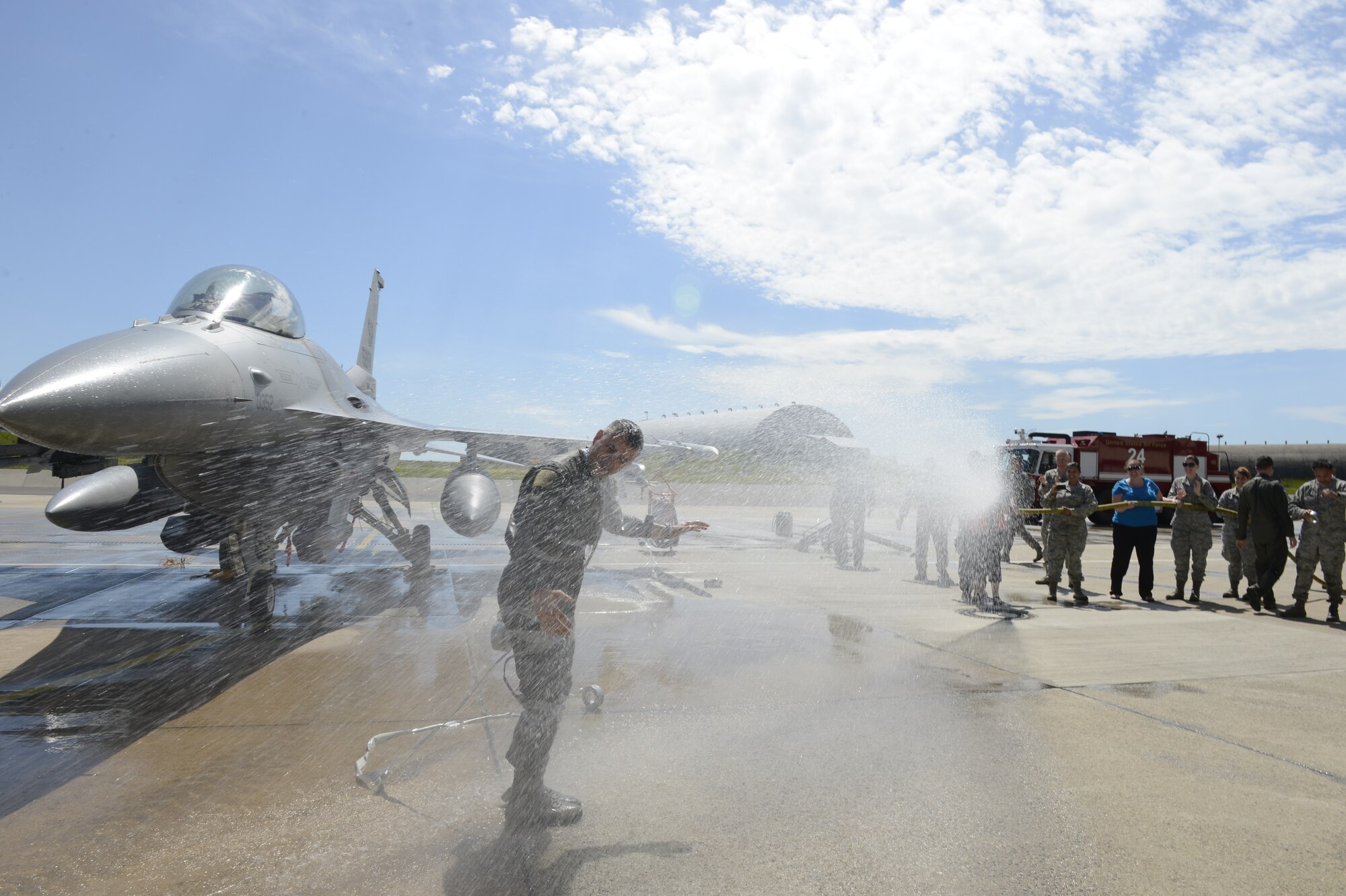 Spangdahlem community members spray U.S. Air Force Col. David Julazadeh, 52nd FW commander, with water after his final flight in an F-16 Fighting Falcon fighter aircraft May, 20, 2014, at Spangdahlem Air Base, Germany. Members throughout the wing attended Julazadeh’s final flight ceremony.  (U.S. Air Force photo by Staff Sgt. Christopher Ruano/Released)