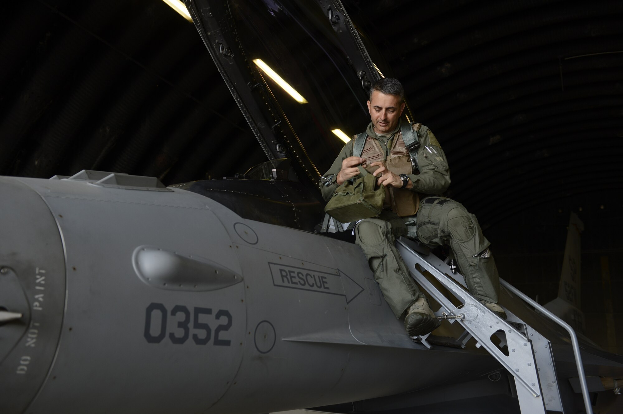 U.S. Air Force Col. David Julazadeh, 52nd Fighter Wing commander, boards a U.S. Air Force F-16 Fighting Falcon fighter aircraft, May, 20, 2014, at Spangdahlem Air Base, Germany. Julazadeh has been the 52nd FW commander for two years and bode farewell during his last flight as a saber. (U.S. Air Force photo by Staff Sgt. Christopher Ruano/Released)