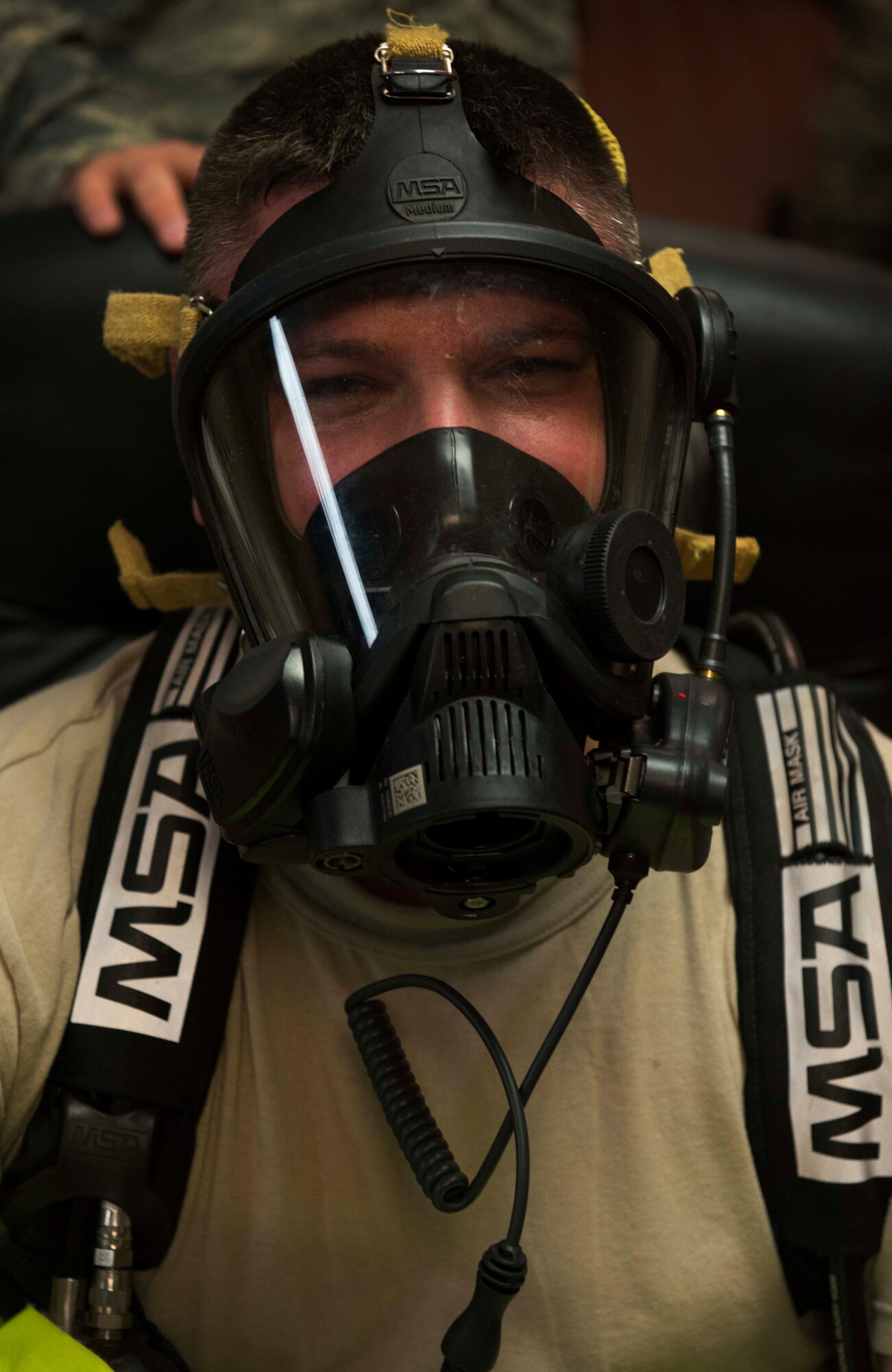 Tech. Sgt Joshua Suggs, 5th Bomb Wing Medical Operations Squadron bioenvironmental engineering technician, tests his mask and oxygen tank before stepping into a full coverage hazmat suit at Minot Air Force Base, N.D., May 8, 2014. Suggs and his shop must test their emergency equipment annually, checking for defects in the masks, tanks and suits. (U.S. Air Force photo/Airman 1st Class Lauren Pitts) 