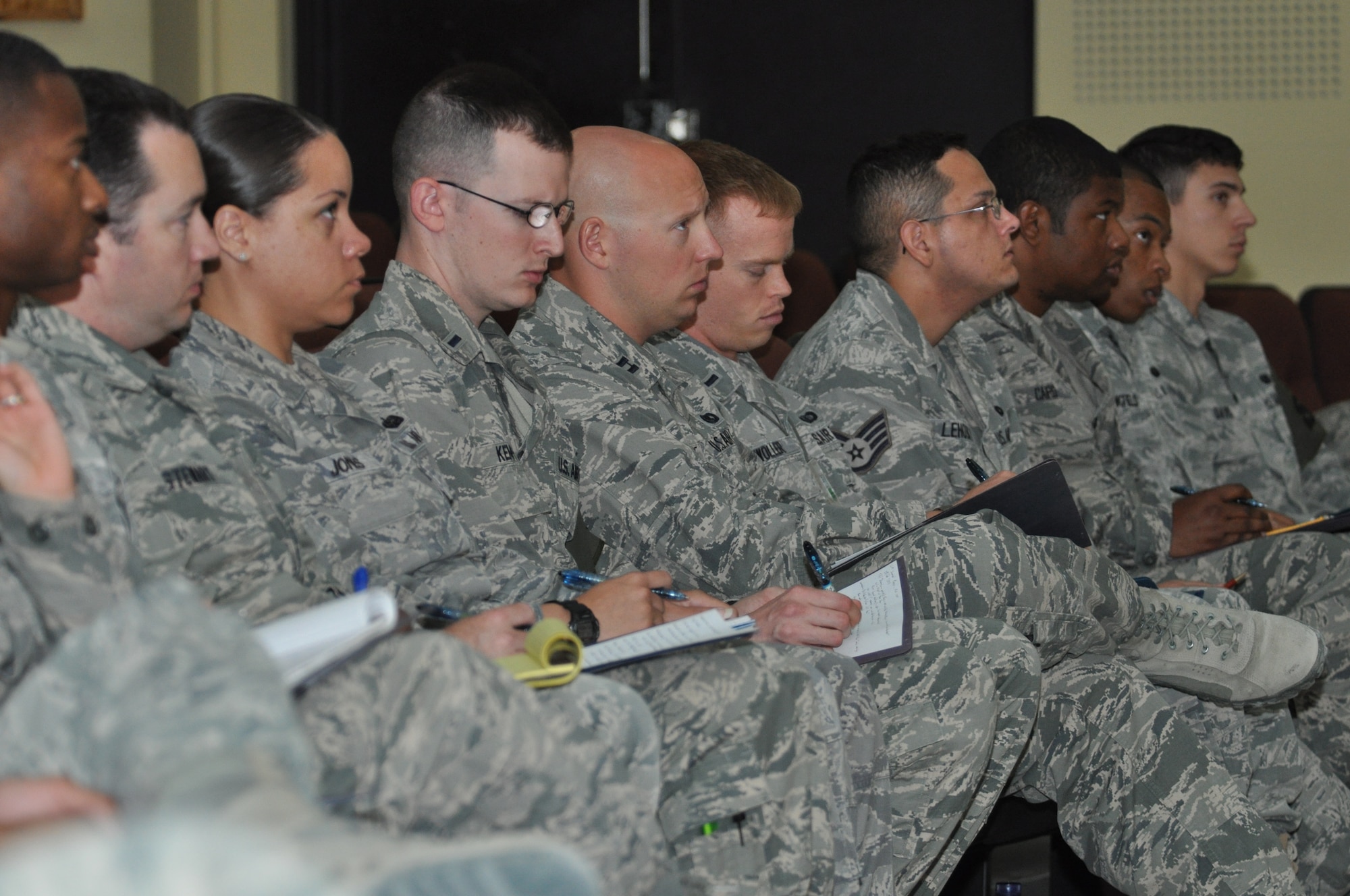 Members of the 12-member panel pay attention and take notes during a mock jury trial at the Rock Theater May 14, 2014 at an undisclosed location in Southwest Asia. Members of the panel, assigned to the 386th Air Expeditionary Wing, had to judge the guilt or innocence of the offender. The mock jury trial was held to educate attendees about the military justice system and the adverse effects of sexual assault. (U.S. Air Force photo by Senior Master Sgt. Allison Day)