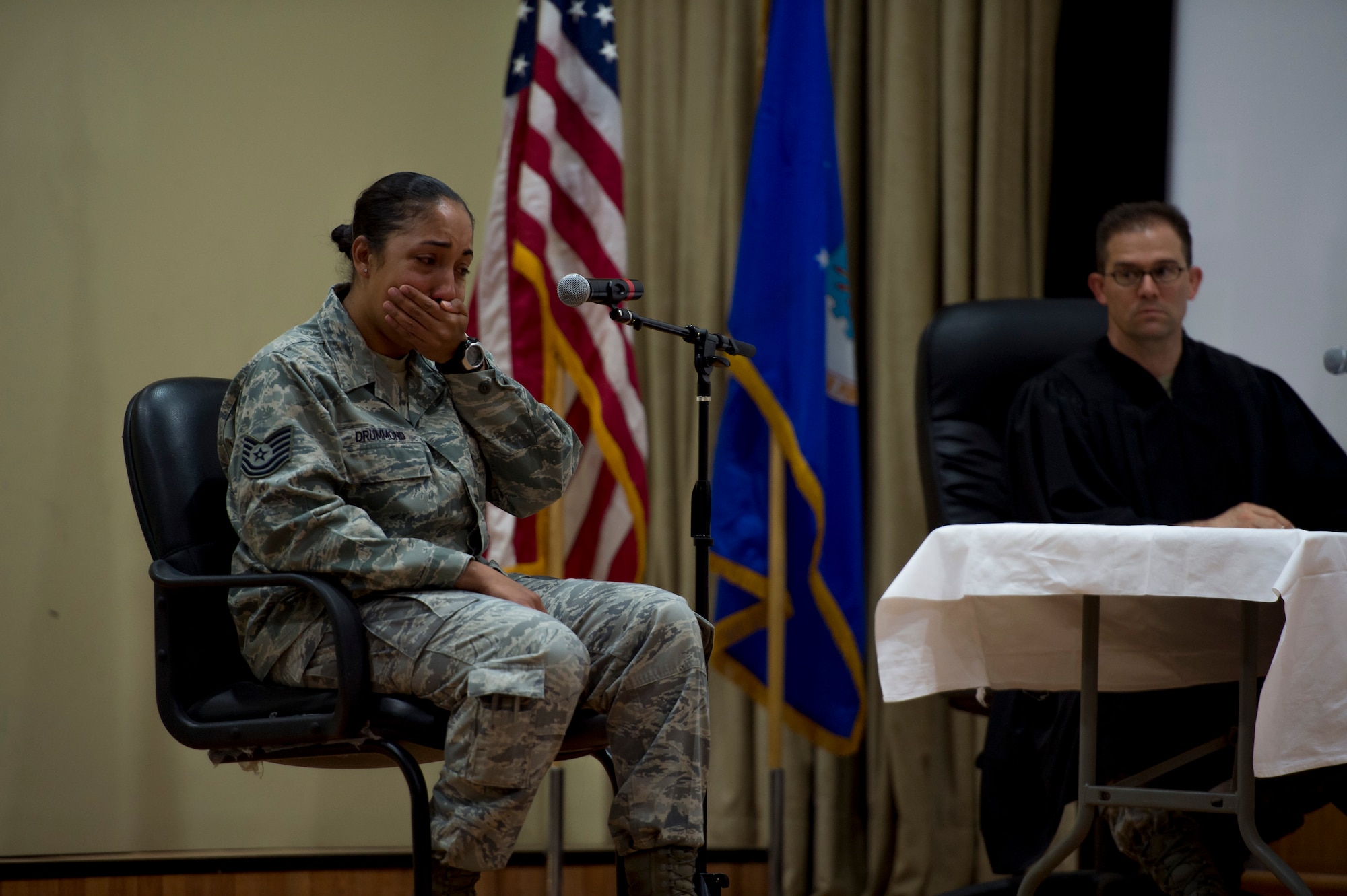 U.S. Air Force Tech. Sgt. Sirrena Drummond, 386th Expeditionary Logistics Readiness Squadron logistics plans superintendent, cries as she gives her testimony at the Rock Theater May 14, 2014 at an undisclosed location in Southwest Asia. Drummond was the victim during the mock jury trial which was held to educate attendees about the military justice system and the adverse effects of sexual assault. (U.S. Air Force photo by Staff Sgt. Jeremy Bowcock)