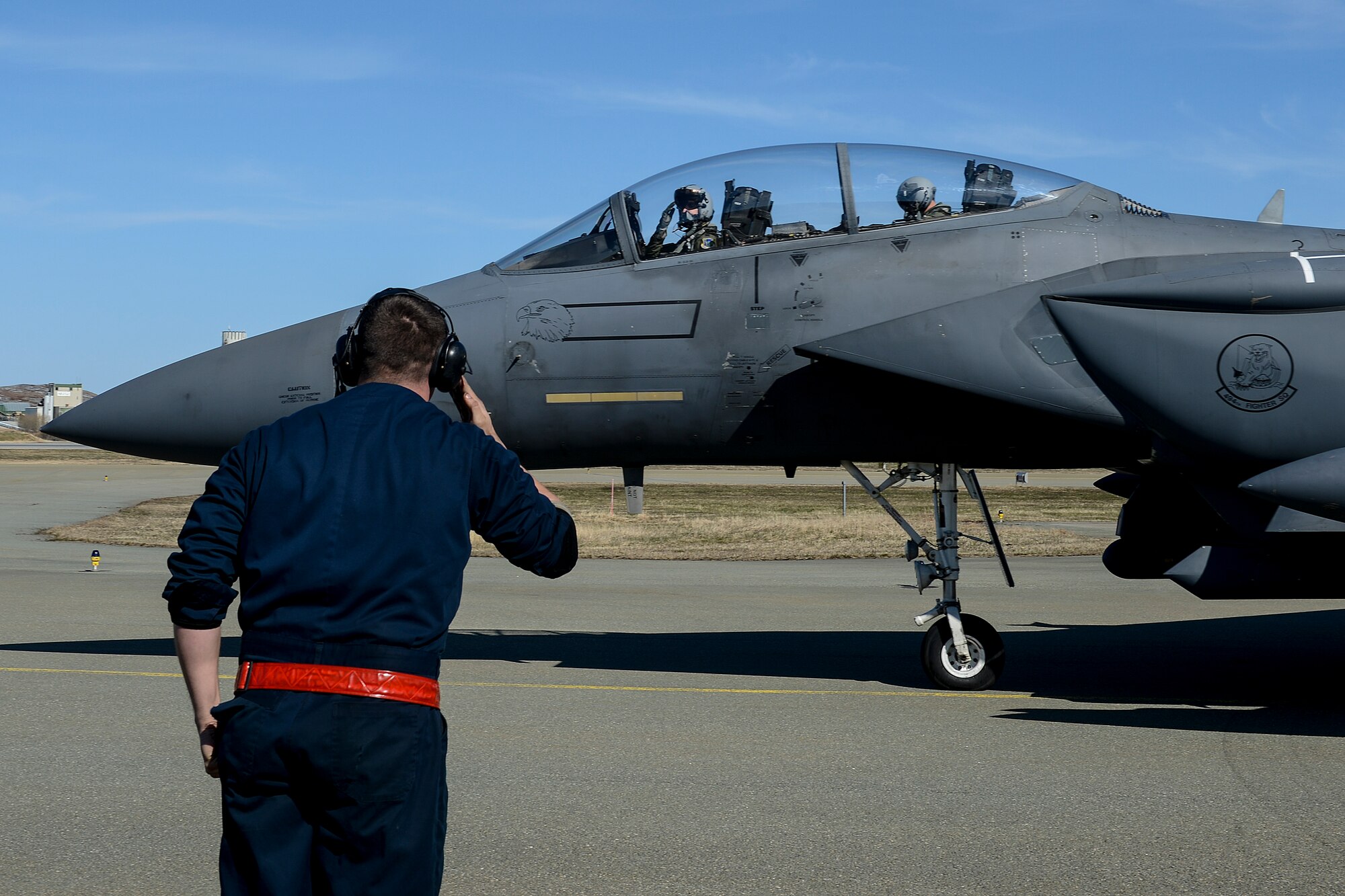 U.S. Air Force Airman 1st Class Collin Terry, 494th Aircraft Maintenance Unit crew chief, salutes an F-15E Strike Eagle pilot on the flightline at Bodø Main Air Station, Norway, May 8, 2014. The U.S. Air Force worked side-by-side with European allies at the recent Nordic Defense Cooperation exercise to train and build relationships with other nations. (U.S. Air Force photo by Airman 1st Class Trevor T. McBride/Released)