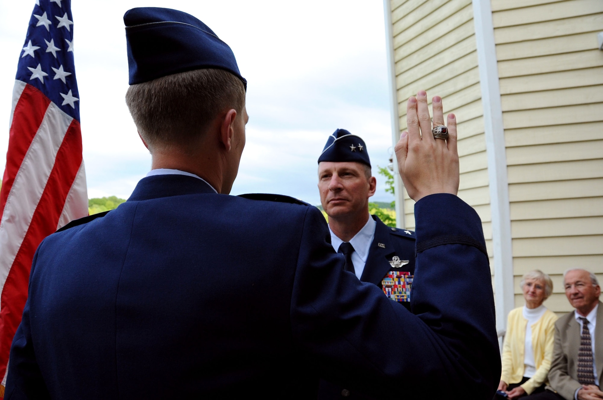 The newly commissioned 2nd Lt. Joe Dolan, gives the Oath of Commissioned Officers to Maj. Gen. John Dolan, Assistant Deputy Commander for U.S. Air Forces Central Command and Assistant Vice Commander for the 9th Air Expeditionary Task Force, during a promotion ceremony in Blacksburg, Va., May 17, 2014. After being a commissioned officer for a mere 24 hours, the new lieutenant proctored his father’s promotion to major general. (U.S. Air Force photo by Staff Sgt. Katherine Holt)
