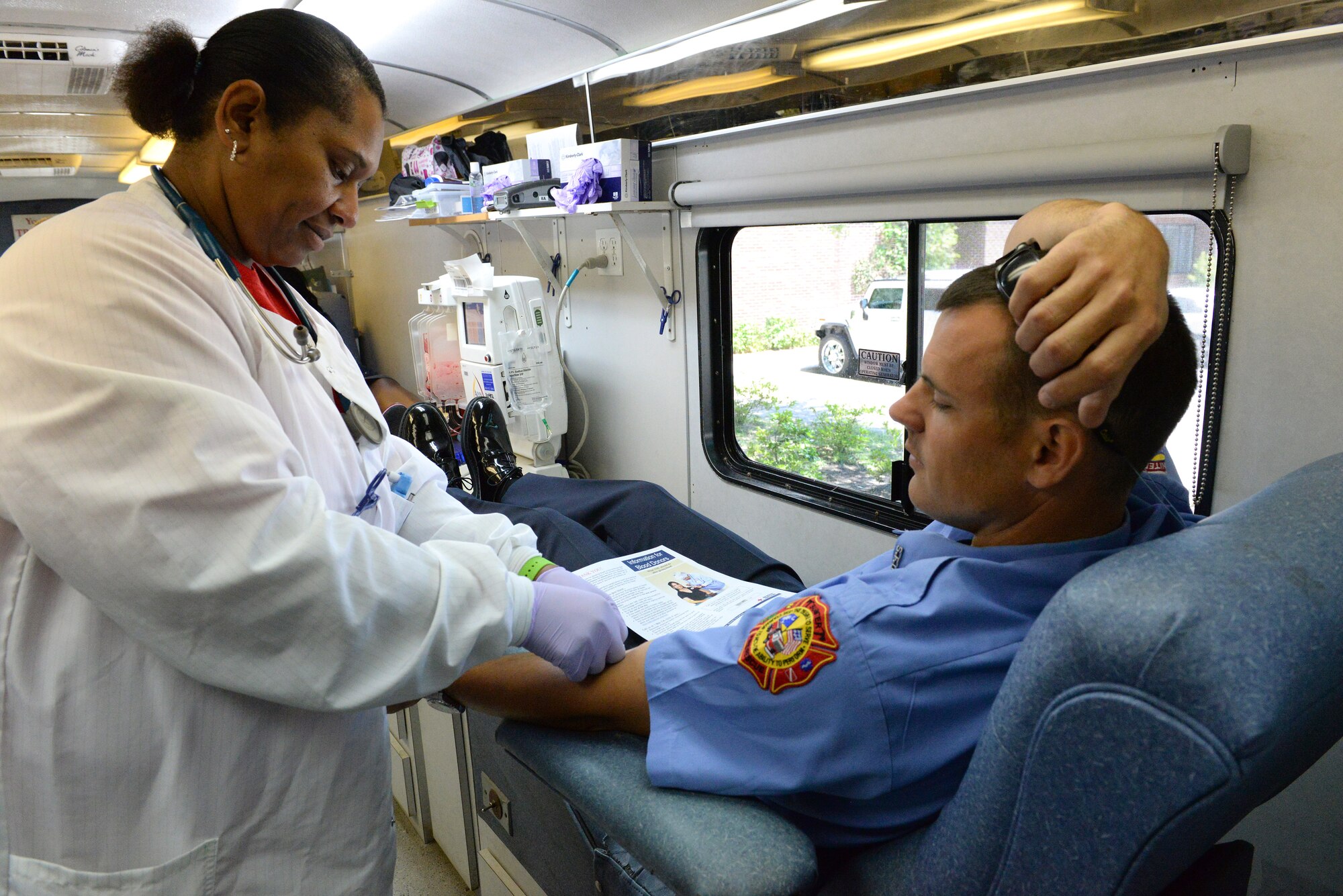 Lyle Wescott, Sumter Fire Department assistant public safety officer, donates blood during a National Police Week blood drive at Sumter County Library, Sumter, S.C., May 16, 2014. Wescott and other Law Enforcement Officers donated blood in memory of Cpl. Chuck Nesbitt, who was killed in 2011 during a vehicle accident. (U.S. Air Force photo by Airman 1st Class Diana M. Cossaboom/Released)