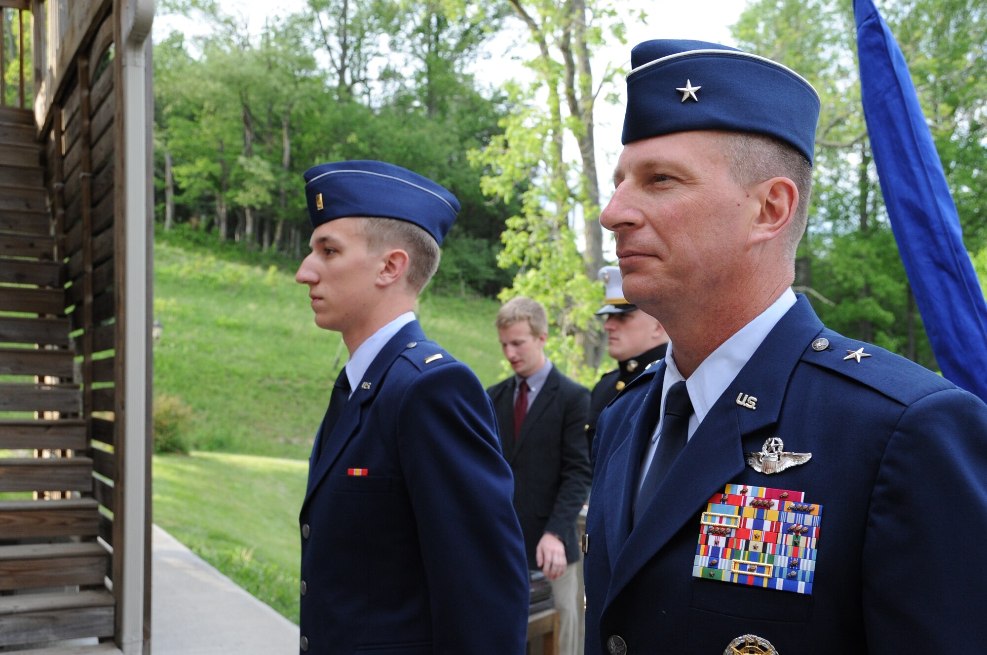 Brig. Gen. John Dolan, Assistant Deputy Commander for U.S. Air Forces Central Command and Assistant Vice Commander for the 9th Air Expeditionary Task Force, and his son, 2nd Lt. Joe Dolan, stand at attention during a promotion ceremony in Blacksburg, Va., May 17, 2014. After being a commissioned officer for a mere 24 hours, the new lieutenant proctored his father’s promotion to major general. (U.S. Air Force photo by Staff Sgt. Katherine Holt)