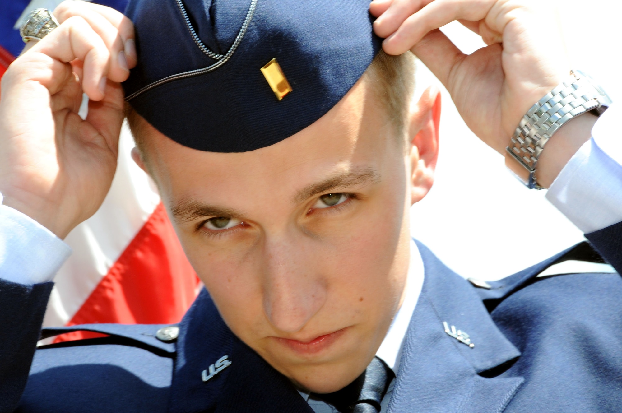 The newly commissioned 2nd Lt. Joe Dolan dons his flight cap after a commissioning ceremony at Virginia Tech University in Blacksburg, Va., May 16, 2014. During his tenure as an Air Force Reserve Officer Training Corps Cadet he assumed multiple leadership positions including cadet wing commander. (U.S. Air Force photo by Staff Sgt. Katherine Holt)