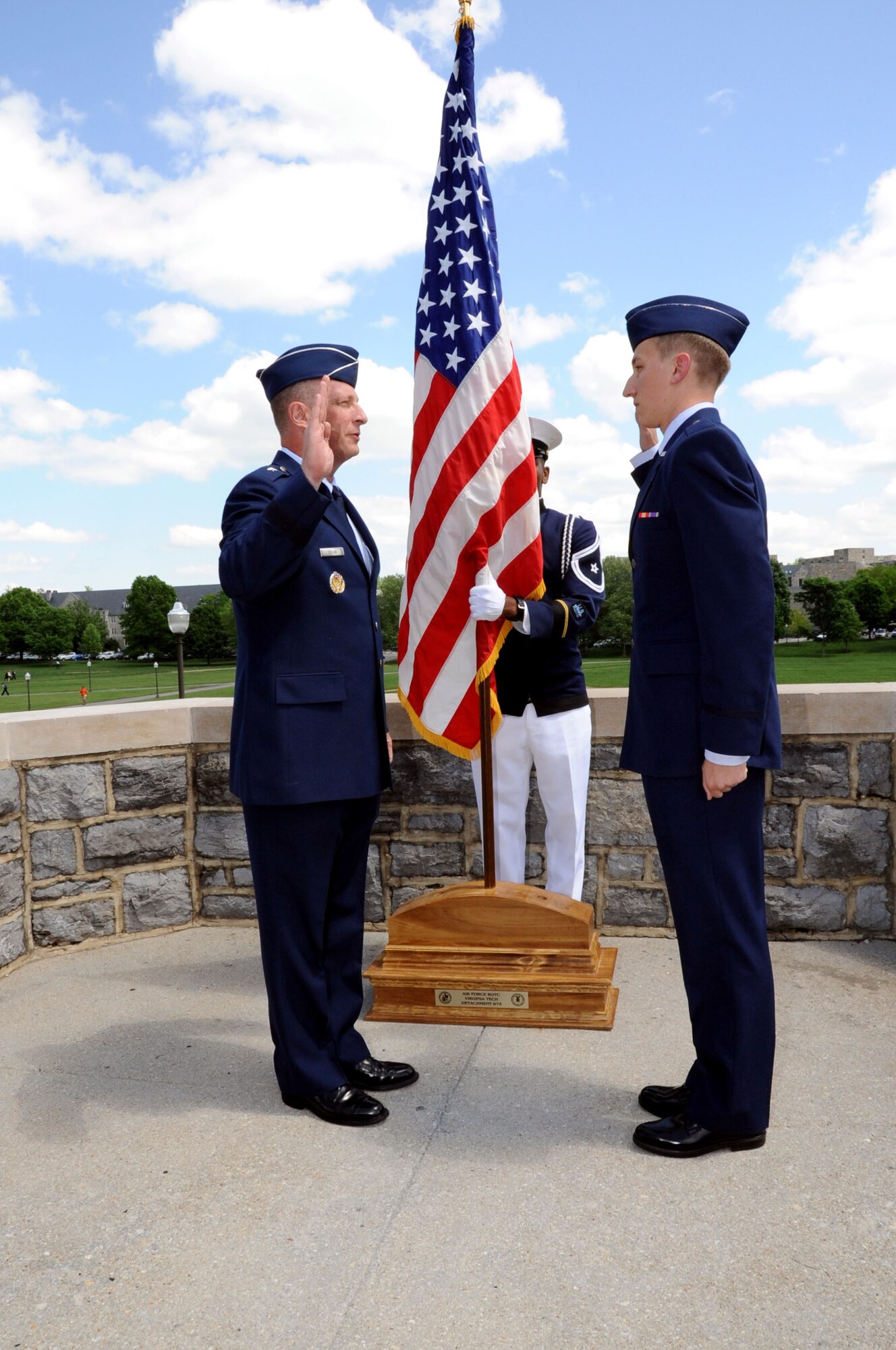 Brig. Gen. John Dolan, Assistant Deputy Commander for U.S. Air Forces Central Command and Assistant Vice Commander for the 9th Air Expeditionary Task Force, gives the Oath of Commissioned Officers to his son, Air Force Reserve Officer Training Corps Cadet Joe Dolan, during a commissioning ceremony at Virginia Tech University in Blacksburg, Va., May 16, 2014. Dolan was named AFROTC Distinguished Graduate and was selected to the remotely-piloted aircraft pilot career field. (U.S. Air Force photo by Staff Sgt. Katherine Holt)