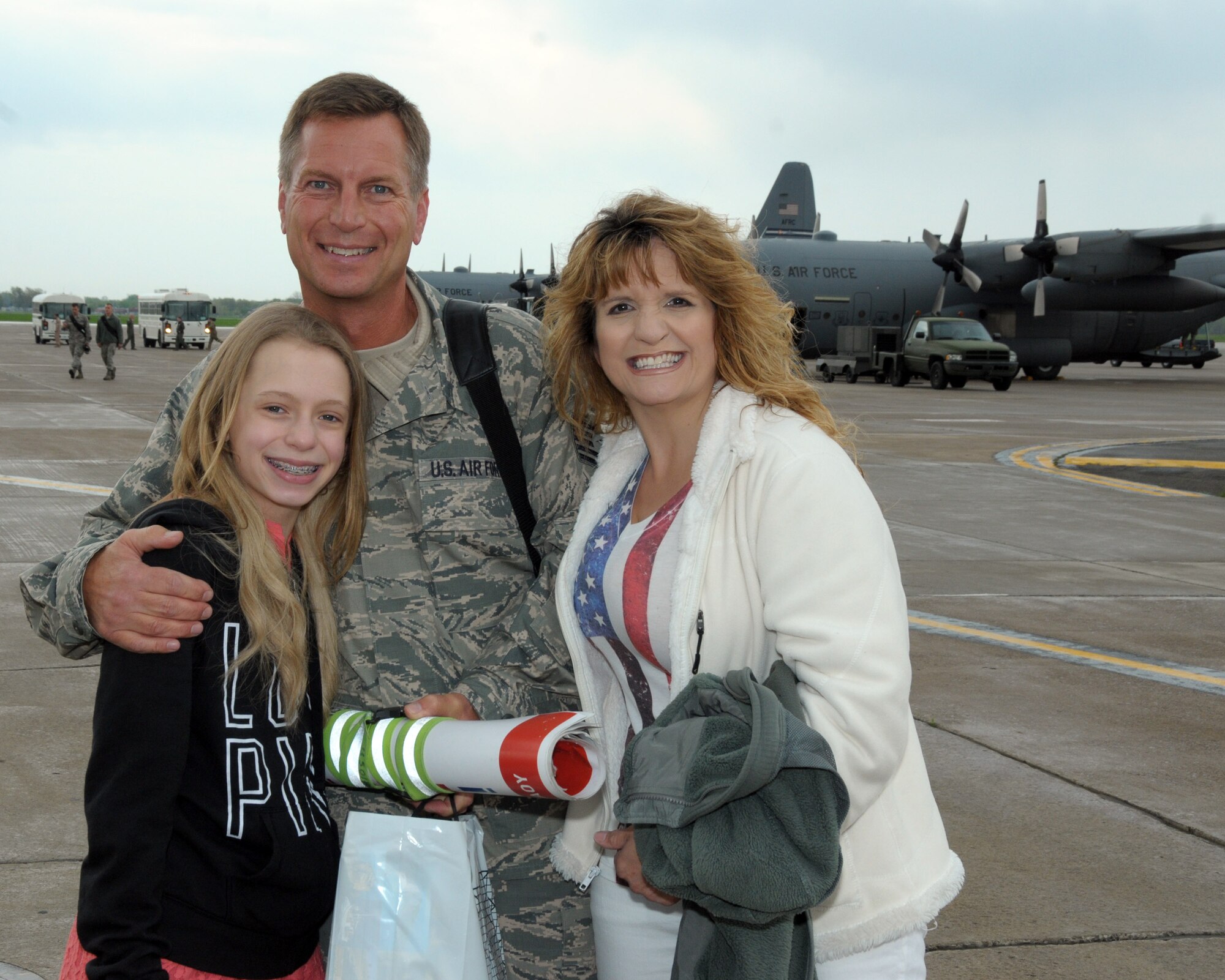 A 914th unit member is all smiles with his family by his side at the Niagara Falls Air Reserve Station, N.Y. May 19, 2014. More than 100 members were deployed overseas recently and have now returned home. (U.S. Air Force photo by Peter Borys)