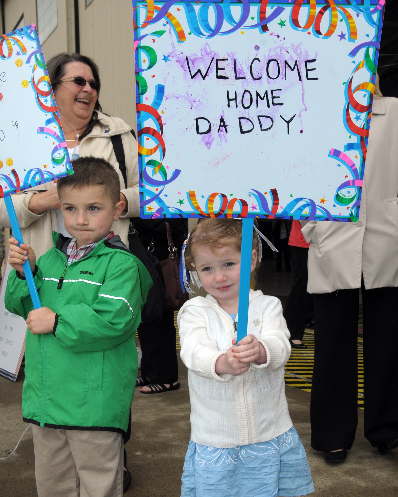 Family members anxiously await their loved ones coming home. Family and friends were on hand at the Niagara Falls Air Reserve Station, N.Y. May 19, 2014 to welcome home members of the 914 th Airlift Wing who were deployed overseas. (U.S. Air Force photo by Peter Borys)