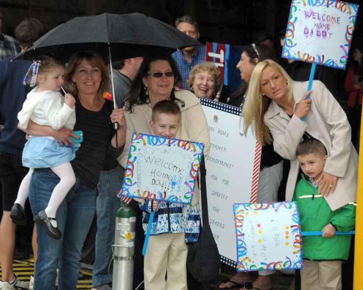 Family members anxiously await their loved ones coming home. Family and friends were on hand at the Niagara Falls Air Reserve Station, N.Y. May 19, 2014 to welcome home members of the 914 th Airlift Wing who were deployed overseas. (U.S. Air Force photo by Peter Borys)