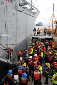 Firefighter students from the Hampton Roads Marine Firefighting School prepare to extinguish a fire during a maritime incident response exercise at Fort Eustis, Va., May 16, 2014. Approximately 115 firefighters from more than 10 local, national and international agencies participated in the exercise, which taught students how to respond to and extinguish shipboard fires. (U.S. Air Force photo by Staff Sgt. Katie Gar Ward/Released)
