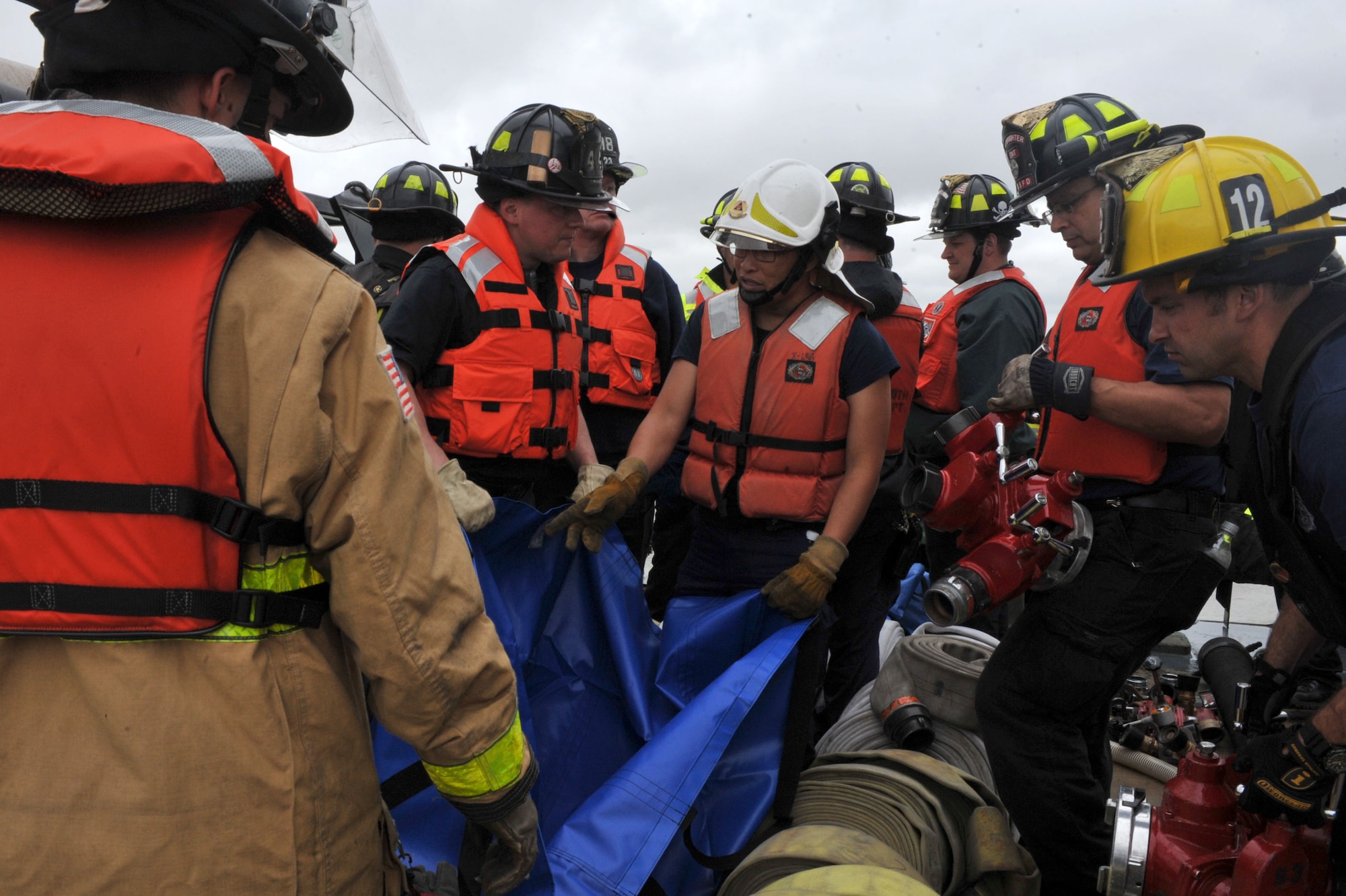 Firefighter students from the 23rd Annual Hampton Roads Marine Firefighting School prepare equipment for a maritime incident response exercise at Fort Eustis, Va., May 16, 2014. The exercise was the culmination of hands-on and practical training during the five-day school, which started May 12, 2014.  (U.S. Air Force photo by Staff Sgt. Katie Gar Ward/Released)