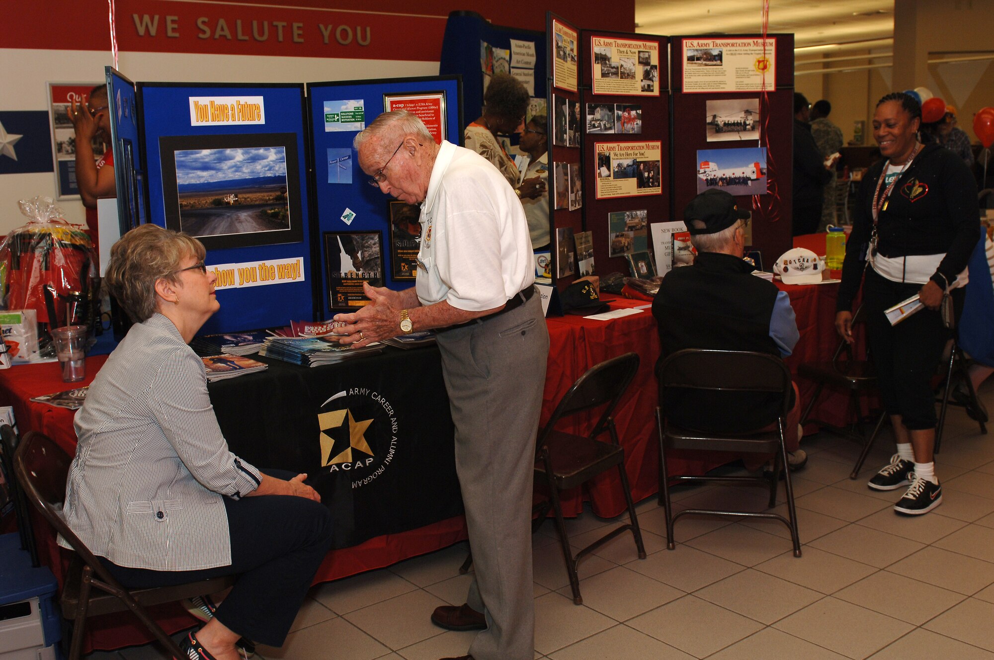 Retirees gather information from different vendors during the annual Retiree Appreciation Day at Fort Eustis, Va., May 17, 2014. Spearheaded by the Fort Eustis Retiree Council, this annual event provides continuity between the retired and active-duty communities. (U.S. Air Force photo by Senior Airman Teresa J.C. Aber/Released)