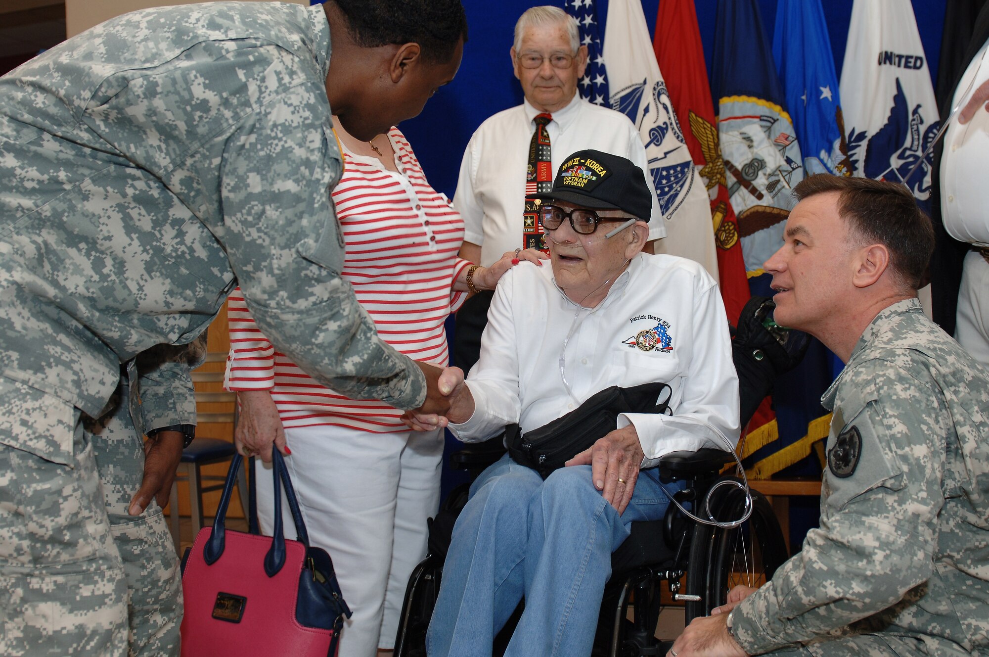 U.S. Army Col. William Galbraith, 733rd Mission Support Group commander and Command Sgt. Maj. Jessie Sharpe, 733rd MSG command sergeant major, shake hands with Eulan Chism, a retired World War II veteran during the annual Retiree Appreciation Day at Fort Eustis, Va., May 17, 2014. The event featured Glabraith as the guest speaker, informational booths, Exchange and commissary specials and bingo. (U.S. Air Force photo by Senior Airman Teresa J.C. Aber/Released) 
