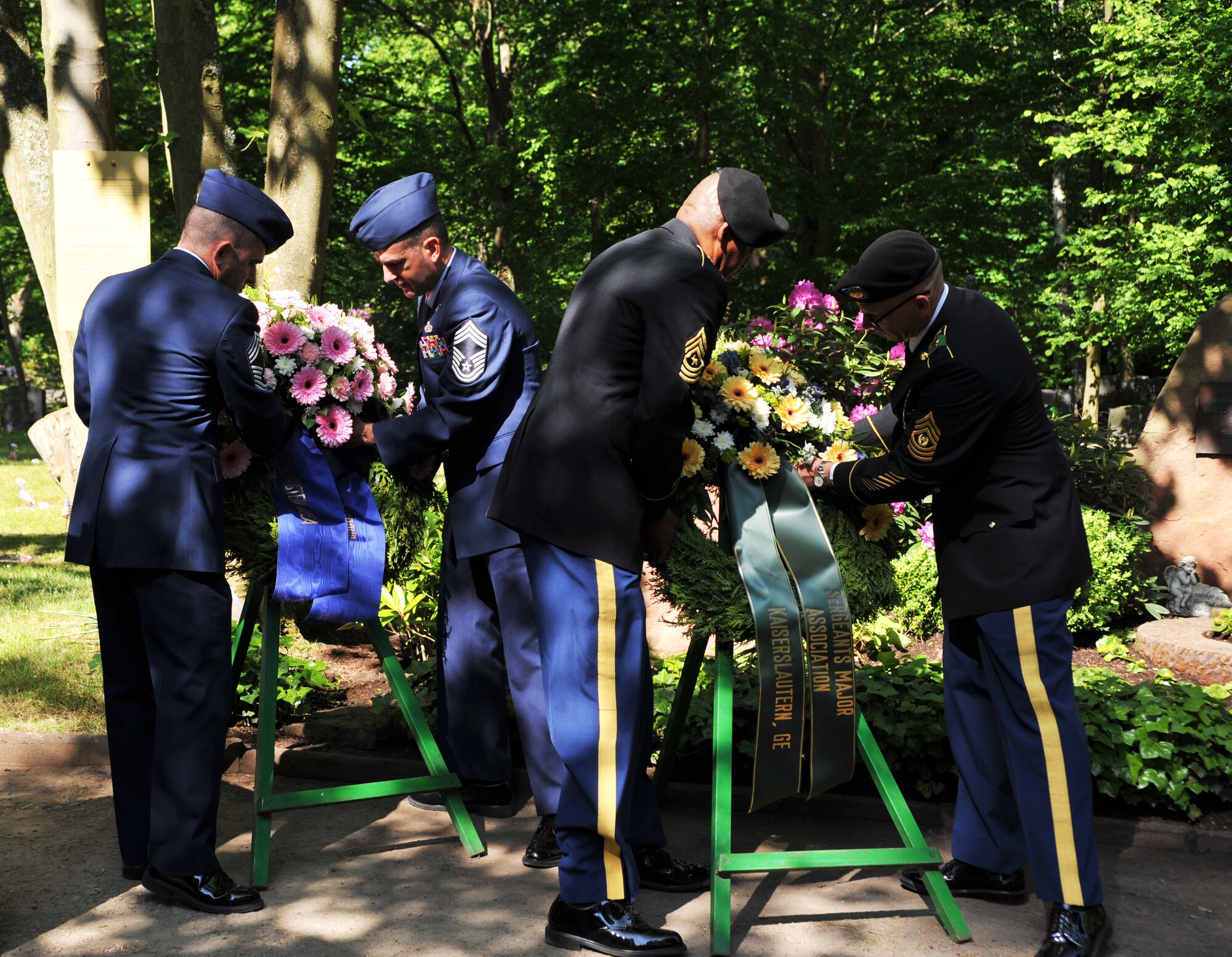 U.S. Air Force and Army personnel present wreaths in honor of their respective branches during the Kindergrave’s ceremony at the Kaiserslautern cemetery, Germany, May 17, 2014. This ceremony is held every year the Saturday after Mother’s Day to keep the children’s memories alive. (U.S. Air Force photo/Senior Airman Hailey Haux)