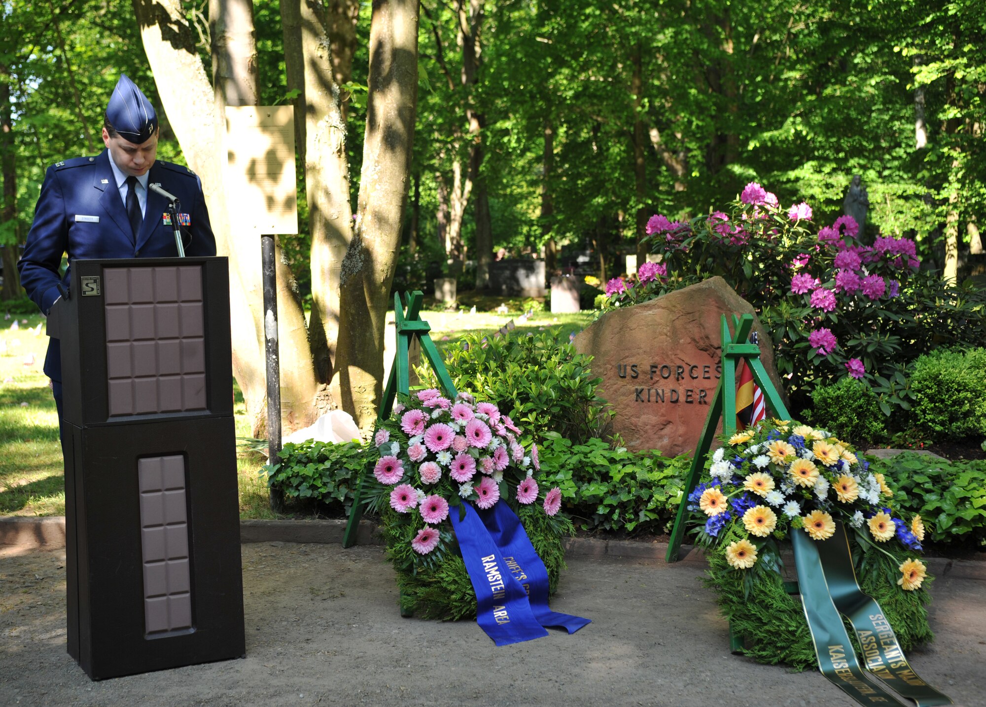 Chaplain (Capt.) Matthew Streett, 86th Airlift Wing, offers the invocation during the Kindergrave’s ceremony at the Kaiserslautern cemetery, Germany, May 17, 2014. A ceremony is held every year the Saturday after Mother’s Day to keep the children’s memories alive. (U.S. Air Force photo/Senior Airman Hailey Haux)