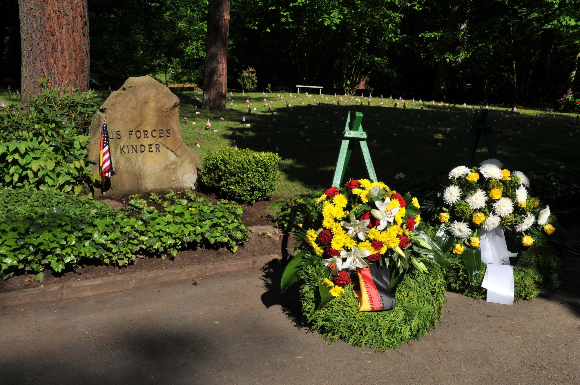 Two wreaths lay in front of the Kindergrave memorial site at the Kaiserslautern cemetery, Germany, May 17, 2014. This ceremony is held every year the Saturday after Mother’s Day to keep the children’s memories alive. (U.S. Air Force photo/Senior Airman Hailey Haux) 