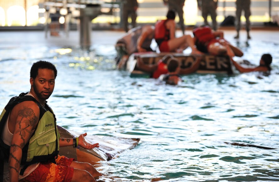 Battle of the Battleships participants go through the challenge round where the last boat left floating wins at the base aquatic center on Ramstein Air Base, Germany, May 16, 2014. Battle of the Battleships is an annual competition hosted by the 86th Force Support Squadron in which teams construct boats out of cardboard and duct tape, then race them to and from the other end of the pool. (U.S. Air Force photo/Senior Airman Hailey Haux)