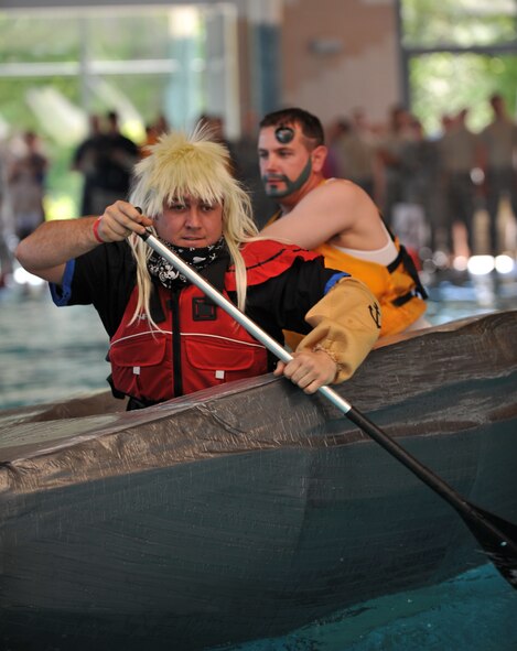 Battle of the Battleships participants paddle to one end of the pool in hopes of being the next winners at the base aquatic center on Ramstein Air Base, Germany, May 16, 2014. Battle of the Battleships is an annual competition hosted by the 86th Force Support Squadron in which teams construct boats out of cardboard and duct tape, then race them to and from the other end of the pool. (U.S. Air Force photo/Senior Airman Hailey Haux)