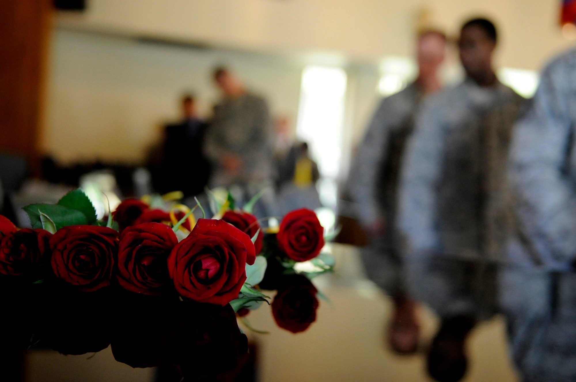 Roses wrapped with a yellow ribbon around the stem are left for the fallen security forces, K-9, and Air Force Office of Special Investigation personnel during a memorial ceremony on Kadena Air Base, Japan, May 16, 2014. The rose symbolizes the blood that was shed, while the yellow ribbon symbolizes individuals who are still deployed in harm's way and the hope that they come back home safe. (U.S. Air Force photo by Airman 1st Class Keith James)