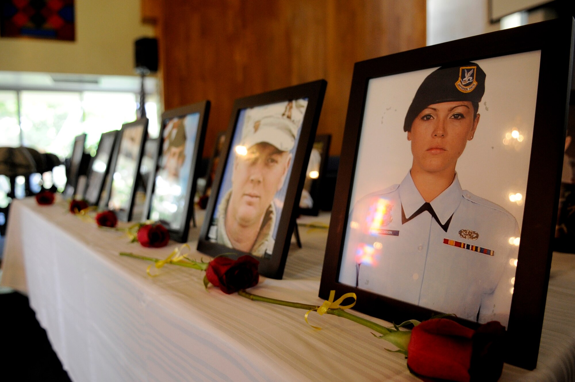 Photos of security forces, K-9, and Air Force Office of Special Investigations personnel are displayed to honor those who have given their lives in the line of duty, during the National Police Week memorial service at Chapel Two on Kadena Air Base, Japan, May 16, 2014. The memorial wrapped up a week of 18th Security Forces Squadron activities held to honor fallen comrades worldwide. (U.S. Air Force photo by Airman 1st Class Keith James)