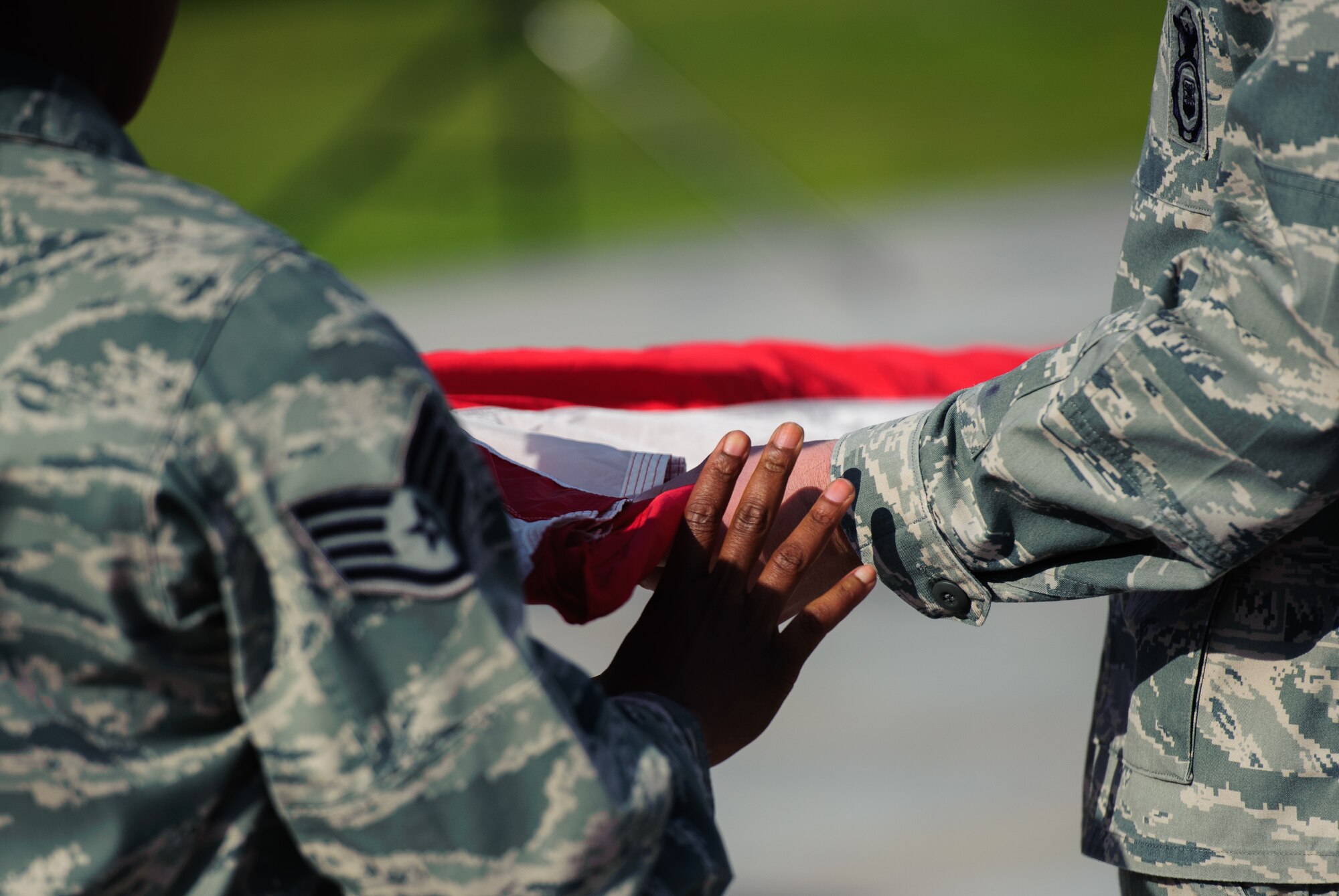 Eight Security Forces Squadron members fold the flag during a retreat ceremony at Kunsan Air Base, Republic of Korea, May 15, 2014. The 8th SFS honored 22 fallen defenders, office of special investigations agents and military working dogs as part of National Police Week. (U.S. Air Force photo by Senior Airman Armando A. Schwier-Morales/Released)