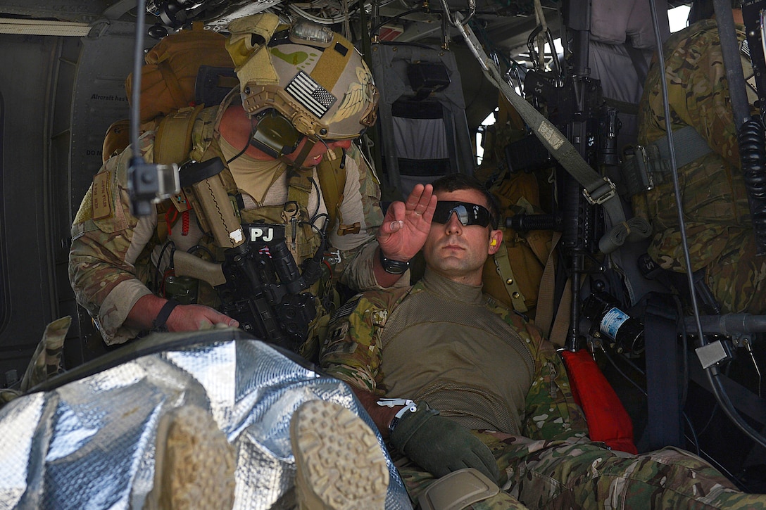 U.S. Air Force Staff Sgt. Justin Tyler treats a simulated casualty in a HH-60G Pave Hawk helicopter during a training exercise on Bagram Airfield, Afghanistan, May 5, 2014. Tyler, a pararescueman element leader, is assigned to the 83rd Expeditionary Rescue Squadron, 455th Air Expeditionary Wing.