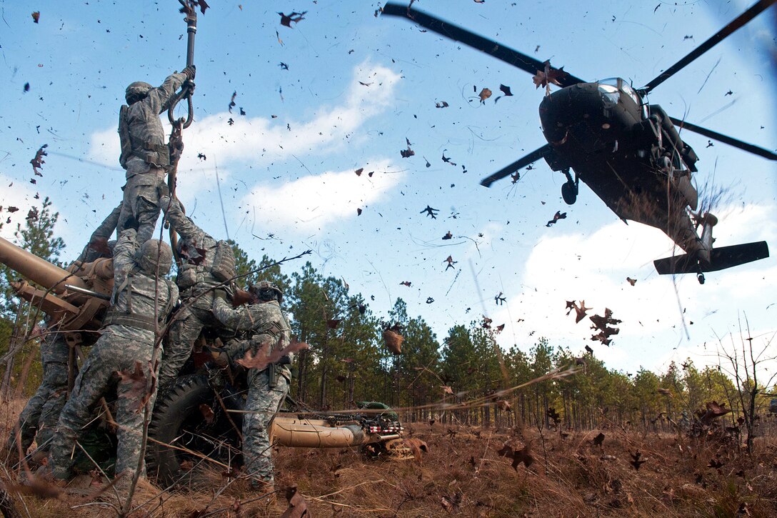 Paratroopers prepare to hook up an M119A2 105mm howitzer to a UH-60 Black Hawk helicopter during air assault training on Fort Bragg, N.C., Feb. 8, 2013. The paratroopers are assigned to the 82nd Airborne Division’s 3rd Battalion, 319th Airborne Field Artillery Regiment, 1st Brigade Combat Team.  
