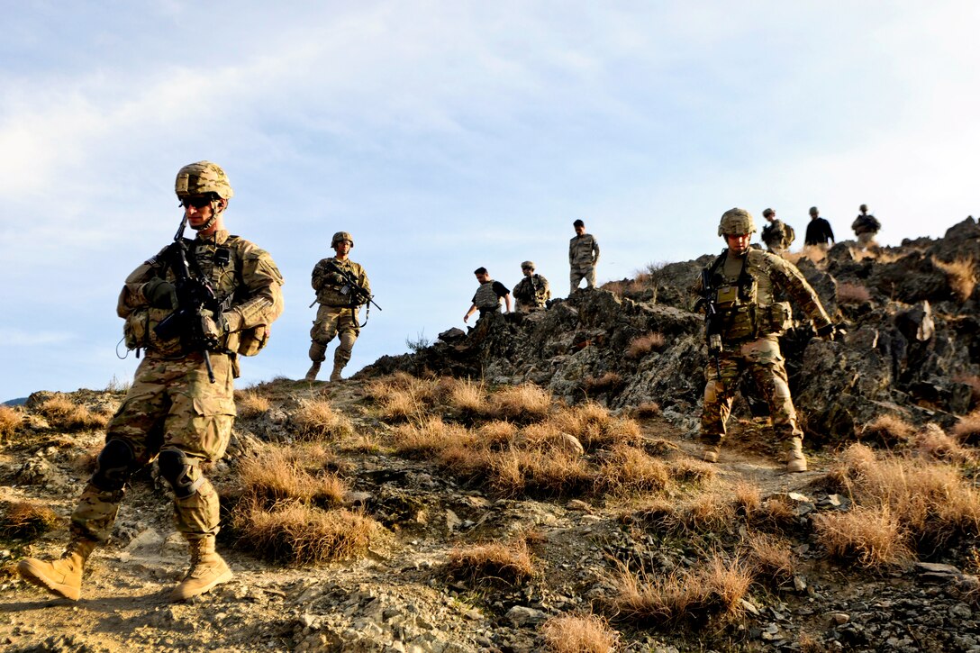 U.S. soldiers patrol down a mountain after visiting an Afghan border police observation point in Kunar province, Afghanistan, Jan. 28, 2013. 
