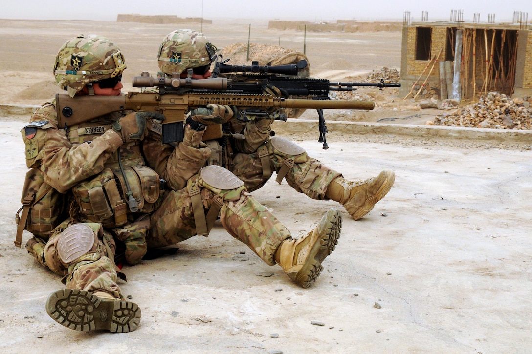 A sniper team scans the area outside of a leaders' shura from a rooftop in the village of Baki Tanna in the Spin Boldak district of Kandahar province, Afghanistan, Jan. 30, 2013. The soldiers are assigned to the 2nd Battalion, 23rd Infantry Regiment.  
