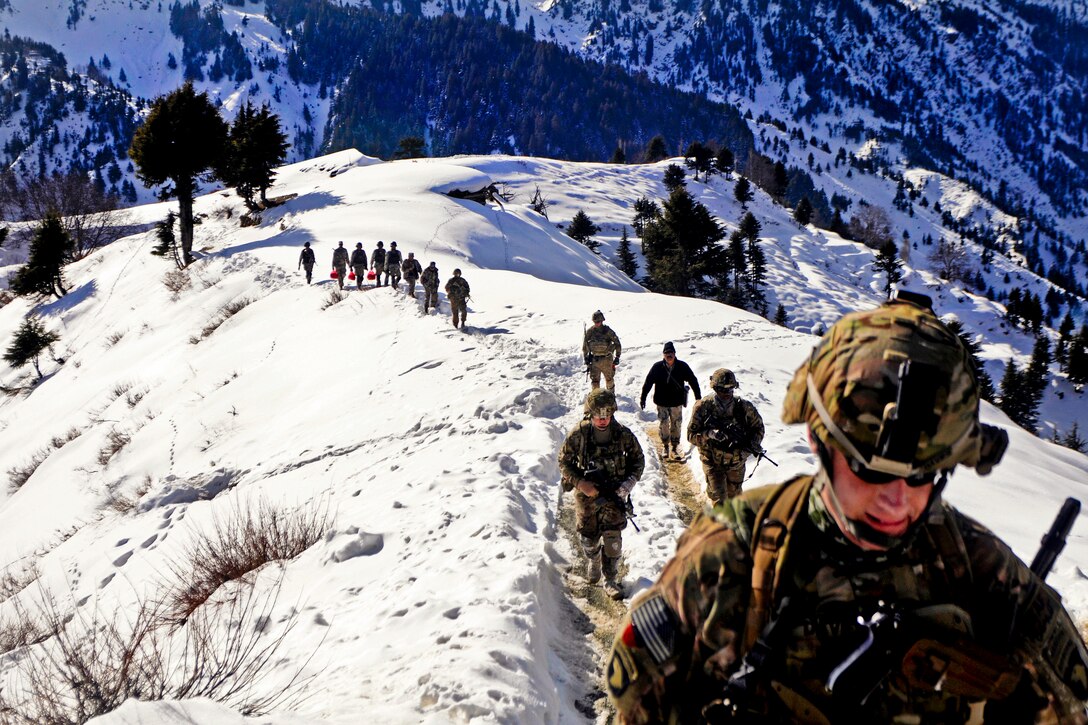 U.S. soldiers and Afghan border police hike from their landing zone to Observation Point 12 along the Afghanistan-Pakistan border, Jan. 21, 2013. The soldiers are assigned to the 101st Airborne Division's 1st Brigade Combat Team.  
