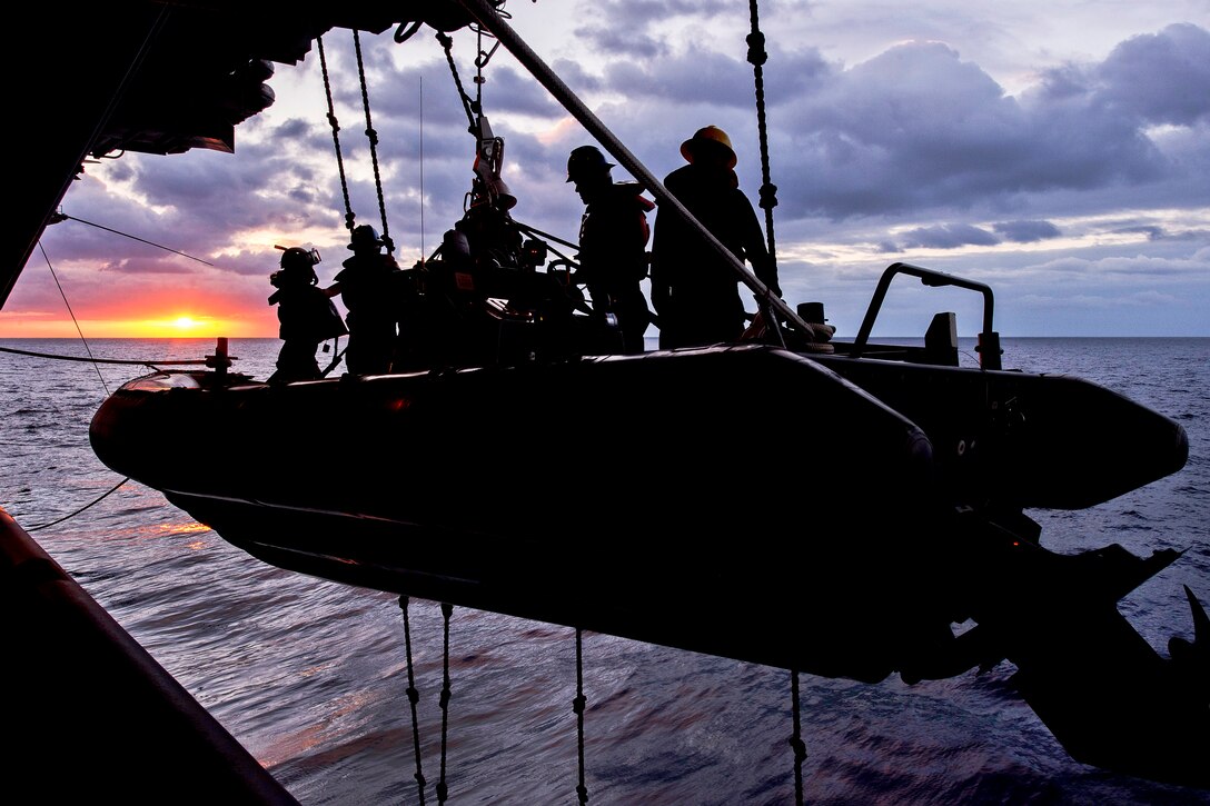 A search and rescue team aboard the USS Harry S. Truman launches a rigid hull inflatable boat during a man-overboard drill in the Atlantic Ocean, Jan. 29, 2013. The Truman is conducting a composite training unit exercise to prepare for its upcoming deployment. 
