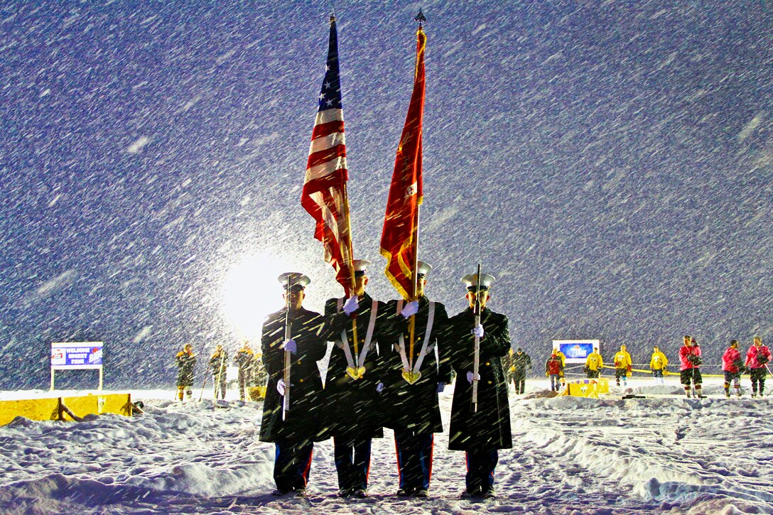Marines present the colors in temperatures with a sub-zero wind chill on the frozen surface of a lake during the opening ceremony for the Grand Rapids Pond Hockey Classic in Grand Rapids, Mich., Jan. 25, 2013. The Marines are assigned to Recruiting Station Lansing, Recruiting Substations Grand Rapids North and South.  
