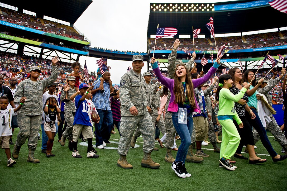 Several hundred service members and their families assigned to bases throughout Hawaii walk onto the field during the 2013 Pro Bowl halftime show at Aloha Stadium in Honolulu, Jan. 27, 2013. The NFL game honored service members and their families.  
