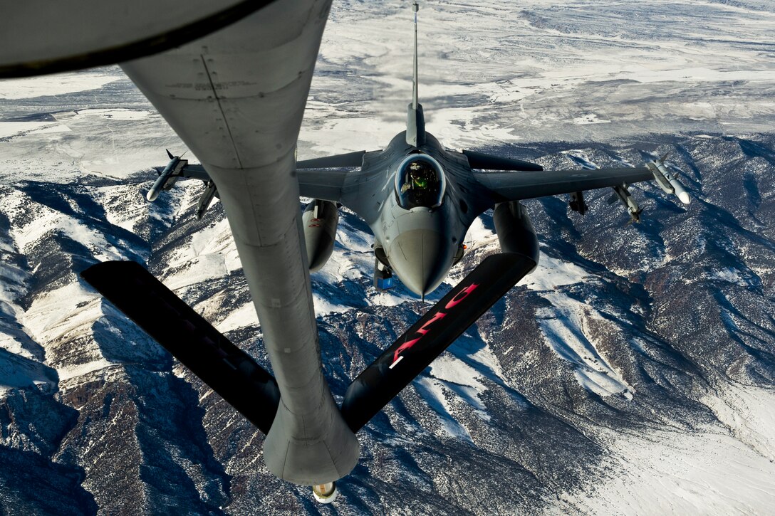 Air Force Lt. Col. Casey maneuvers into position behind a 151st Air Refueling Wing KC-135 to receive fuel during a training mission near a range in Utah, Jan. 18, 2013. The refueling wing routinely supports air operations across the western United States. Casey is a pilot assigned to the 421st Fighter Squadron.  
