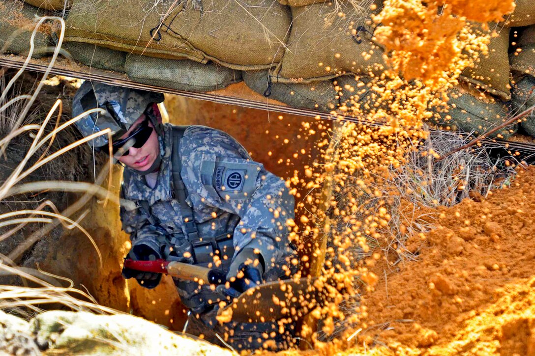 Army Spc. David R. King digs a fighting position during a field training exercise on Fort Bragg, N.C., Jan. 12, 2013. King, a cavalry scout, is assigned to the 82nd Airborne Division's Headquarters Company, 2nd Brigade Combat Team. The division continuously trains to execute forcible entry operations anywhere in the world on short notice.  
