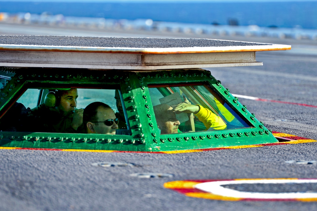 U.S. sailors observe flight operations on the flight deck aboard the aircraft carrier USS George H.W. Bush under way in the Atlantic Ocean, Jan. 10, 2013.  
