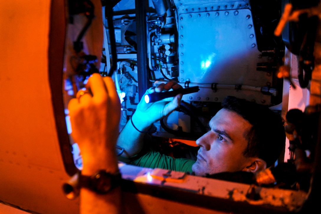 U.S. Navy Petty Officer 1st Class Justin Sexton inspects the gun cavity of an F/A-18E Super Hornet aboard the aircraft carrier USS John C. Stennis in the U.S. 5th Fleet area of responsibility, Jan. 9, 2013. The Stennis is conducting maritime security operations, theater security cooperation efforts and support missions for Operation Enduring Freedom. Sexton is an aviation technician and the aircraft is assigned to Strike Fighter Squadron 14.  
