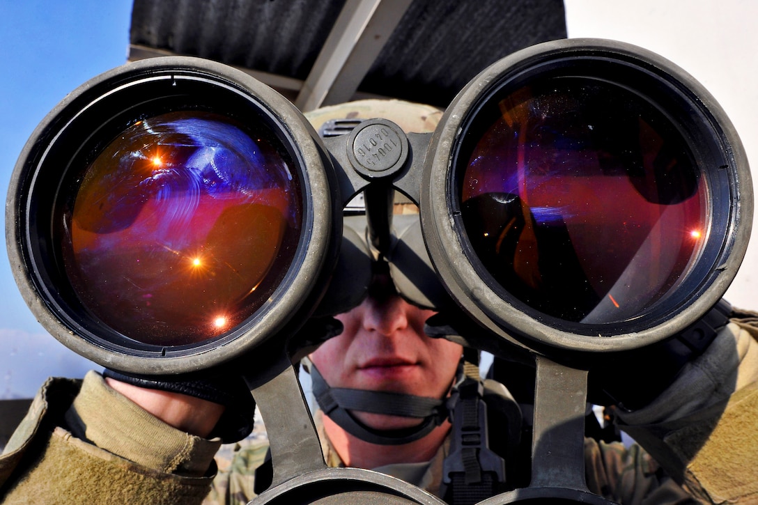 U.S. Air Force Airman 1st Class Lee Borytsky scans the perimeter around his guard tower on Bagram Airfield, Afghanistan, Jan. 10, 2013. Borytsky is assigned to the 455th Expeditionary Security Forces Squadron. The unit's members mans the guard towers surrounding the base, armed with powerful binoculars and other hi-tech surveillance gear to watch for threats.  
