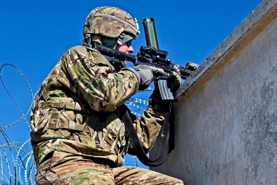 A U.S. soldier provides security along a wall on Combat Out Post Baraki-Barak in Afghanistan's Logar province, Jan. 5, 2013. The soldier is assigned to the 1st Squadron, 91st Calvary Regiment, 173rd Airborne Brigade Combat Team.  
