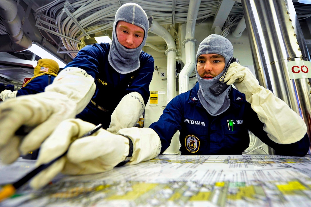 U.S. Navy Ensign Andrew Pfarner and Petty Officer 3rd Class Justin Dintelmann track damage control efforts during a general quarters drill aboard the guided-missile destroyer USS Jason Dunham in the U.S. 5th Fleet area of responsibility, Jan. 4, 2013. The Dunham is deployed with the John C. Stennis Strike Group to conduct maritime security operations, theater security cooperation efforts and support missions for Operation Enduring Freedom.  
