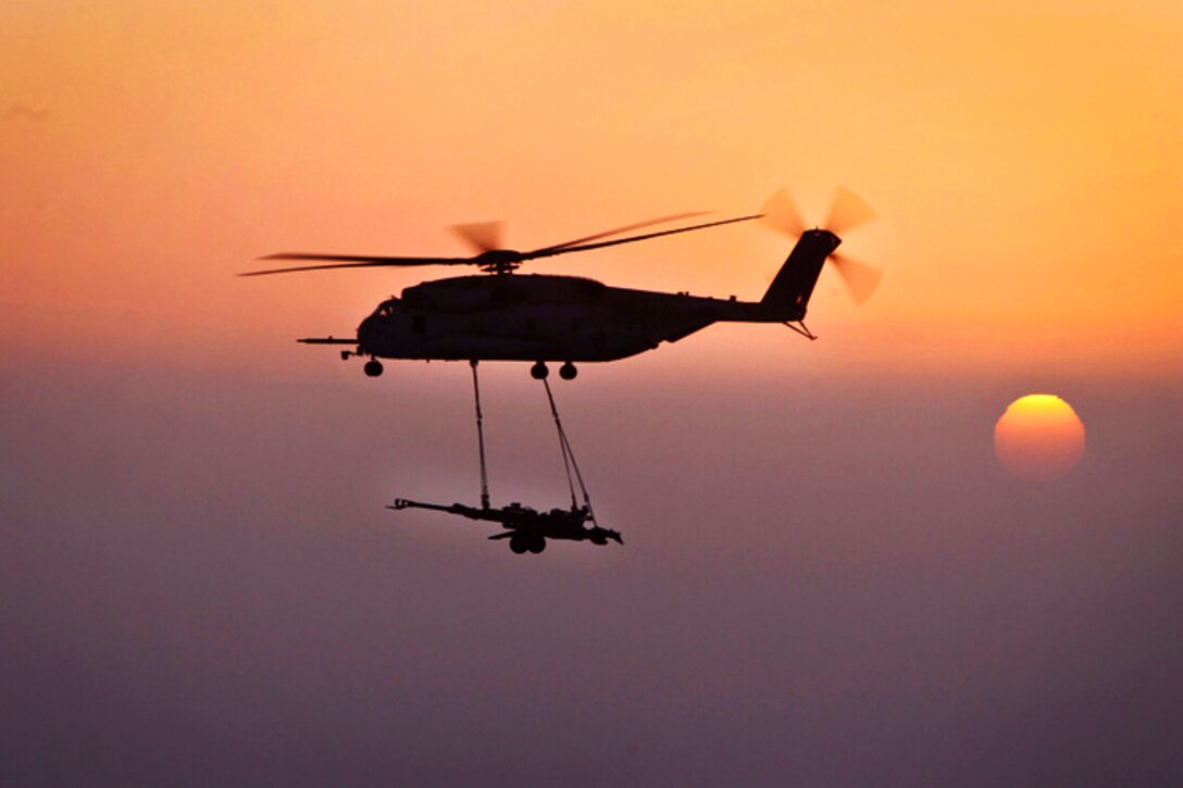 A U.S. Marine Corps CH-53E Super Stallions lifts M777 howitzers over Helmand province, Afghanistan, Dec. 29, 2012. U.S. Marines assigned to Marine Heavy Helicopter Squadron 361, Marine Aircraft Group 16, 3rd Marine Aircraft Wing provided aerial support by repositioning the howitzers to Camp Dwyer.  
