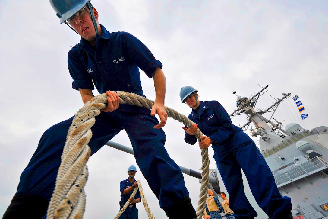 U.S. Navy Seaman Elliot Dreiling, left, and Petty Officer 3rd Class Laurie Volz handle a mooring line as the guided-missile destroyer the USS Jason Dunham departs Bahrain after a port visit in Mina Salman Pier, Dec. 26, 2012. The Dunham is deployed with the John C. Stennis Strike Group to the U.S. 5th Fleet area of responsibility to conduct maritime security operations, theater security cooperation efforts and support missions for Operation Enduring Freedom.  
