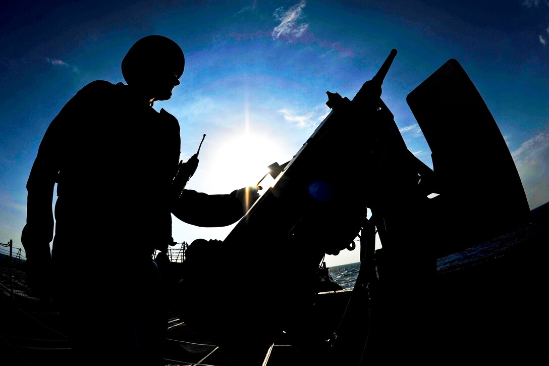 U.S. Navy Petty Officer 3rd Class Travis Hetrick mans an M2HB .50-caliber machine gun aboard the guided missile destroyer the USS Jason Dunham while under way in the U.S. 5th Fleet area of responsibility, Dec. 27, 2012. The Dunham, part of the John C. Stennis Carrier Strike Group, was deployed to conduct maritime security operations and theater security cooperation efforts to support Operation Enduring Freedom.  
