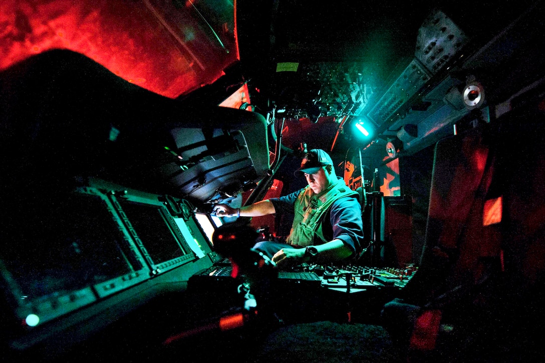 U.S. Navy Petty Officer 1st Class Caleb Gilcrease supplies power to an MH-60R Seahawk helicopter before it launches aboard the guided-missile cruiser the USS Mobile Bay in the U.S. 5the Fleet Area of reponsibility, Dec. 28, 2012. The Mobile Bay is deployed with the John C. Stennis Strike Group to conduct maritime security operations, theater security cooperation efforts and support missions for Operation Enduring Freedom.  
