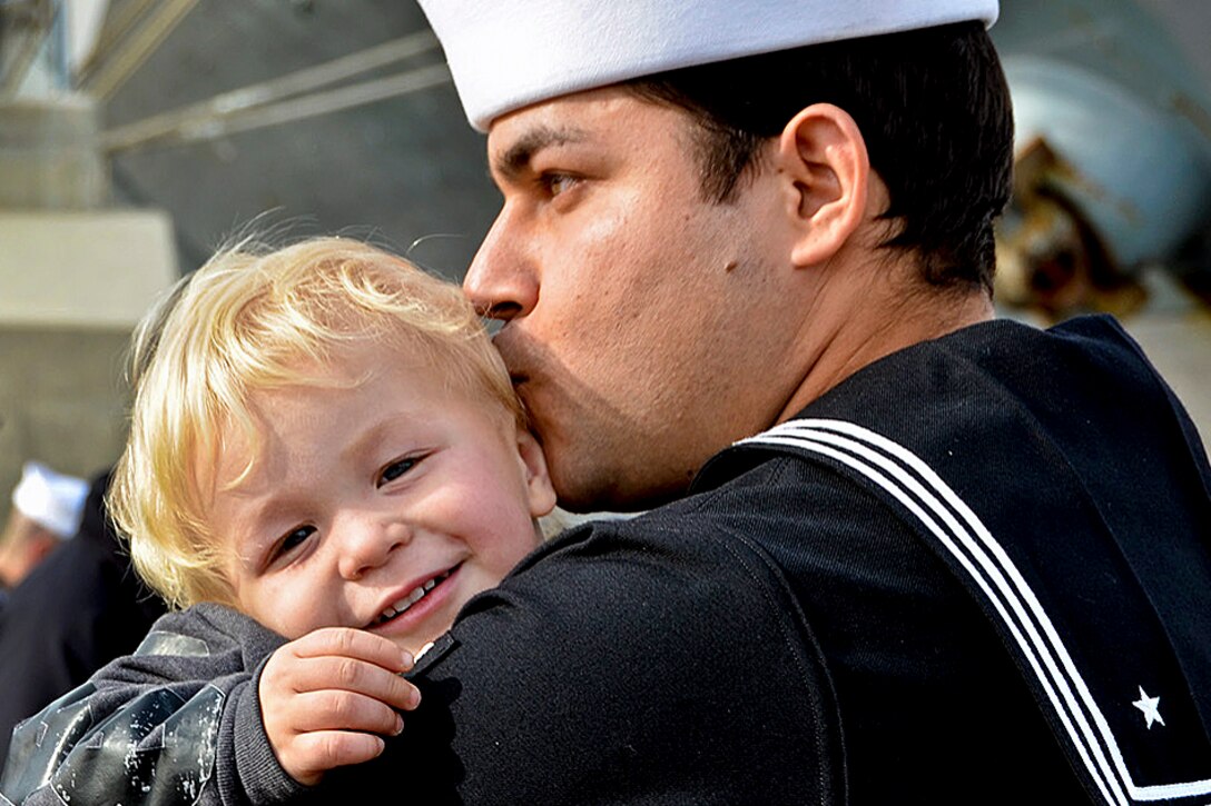 Navy Petty Officer 1st Class Fabio Perez greets his son during a homecoming celebration on Naval Station Norfolk, Va., Dec. 20, 2012, following a regularly scheduled deployment to the areas of responsibility for the U.S. 5th and 6th fleets. The homecoming marks the end of deployment for the Iwo Jima Amphibious Ready Group, during which its ships supported Operation Enduring Freedom, and African Lion and Eager Lion exercises.  
