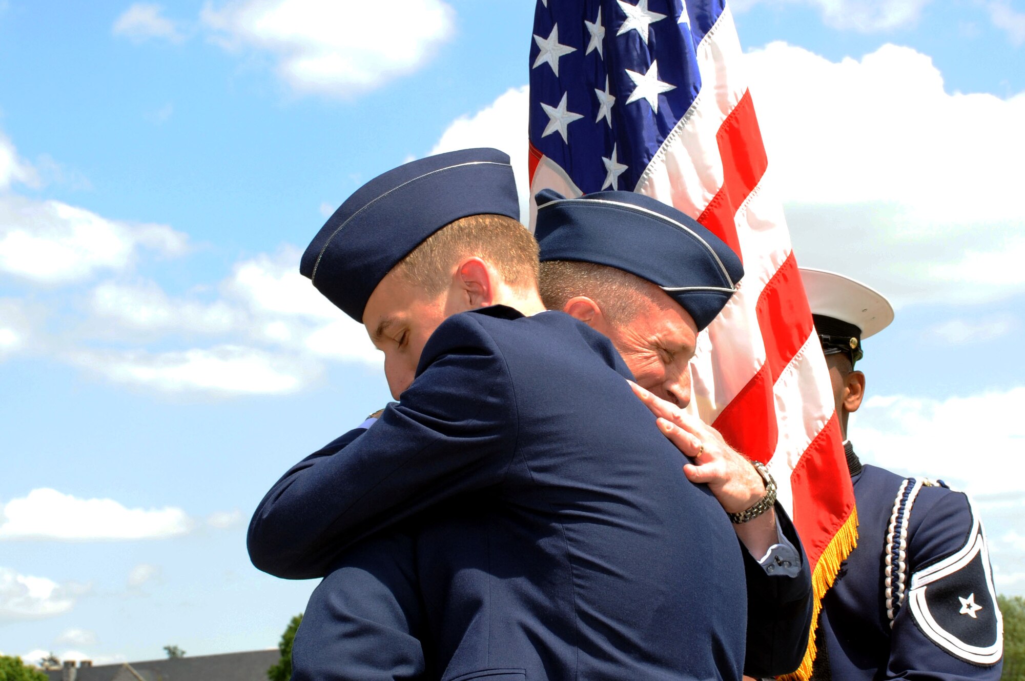 Maj. Gen. John Dolan embraces his son, 2nd Lt. Joe Dolan, during a commissioning ceremony May 16, 2014, at Virginia Tech University in Blacksburg, Va. Joe was named distinguished graduate and will attend training to become a remotely-piloted aircraft pilot. John is the assistant deputy commander for U.S. Air Forces Central Command and assistant vice commander for the 9th Air Expeditionary Task Force. (U.S. Air Force photo/Staff Sgt. Katherine Holt)